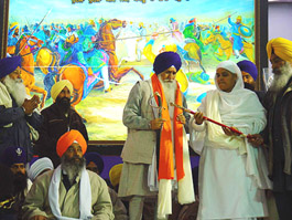 The SGPC chief, Bibi Jagir Kaur, presents a siropa to the Jathedar of Akal Takht, Giani Joginder Singh Vedanti, at the tercentenary of the martyrdom of sahibzadas at Chamkaur Sahib on Monday.