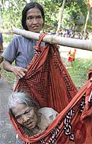 A woman carries her mother while they leave the Car Nicobar Island after the tsunami hit the remote Andaman and Nicobar Islands chain near the epicentre of the quake on Thursday. 