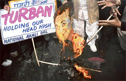 National Akali Dal activists burn a cutout of French President Nicolas Sarkozy during a protest in New Delhi