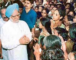 Prime Minister Manmohan Singh listens to the woes of tsunami-affected people at the Muthukulam relief camp in Alapuzha district of Kerala on Friday.