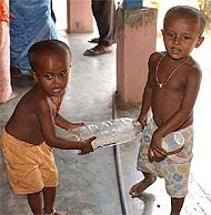 Tiny tots carry water bottles to quench their thirst at a relief camp in Port Blair on Saturday. 