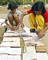 Girls who survived the tsunami dry their soaked books in Port Blair on Tuesday. 