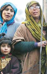 Family members of Mushtaq Ahmad, an income tax employee, wail after his death in an encounter in Srinagar on Saturday.