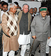 RJD chief Laloo Prasad Yadav and Congress leaders M.L. Fotedar and Arjun Singh come out after a meeting in New Delhi on Sunday