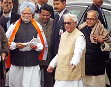 Prime Minister Manmohan Singh being welcomed by Chief Minister of West Bengal Buddhadeb Bhattacharya after his arrival at the Kolkata airport on Tuesday, while Defence Minister Pranab Mukherjee looks on. 