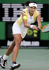 Sania Mirza hits a return against seventh-seeded Serena Williams in their third-round match at the Australian Open Tennis Tournament in Melbourne on Friday. 