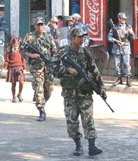 Nepalese soldiers patrol a street near the Kings Palace complex in Kathmandu on Tuesday.