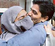 Ms Nuzhat Dar, a candidate of the National Conference, is hugged by a senior supporter on her victory from Nawab Bazar in the Srinagar Municipal Corporation elections in Srinagar on Wednesday.