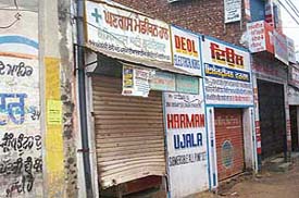 The broken shutter of a shop in Mandi Ahmedgarh.