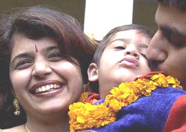 Eighteen-month-old Arpit Dewan from Delhi, who was kidnapped by the house maid Savitri and later rescued from Rajganjpur village of Orissa, with his parents Arvind and Bharti at Srinivaspuri Police Station after Delhi police personnel brought him back on Sunday.