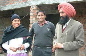 Mr Balwinder Singh Sandhu, his son Gagandeep Singh and his wife Jagdish Kaur at their house in Bhikhiwind, which was attacked by terrorists more than 40 times