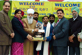 Ravinder Ravi being honoured by Mr H.S. Hanspal, PPCC chief, at a function