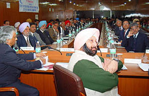 Punjab Chief Minister Capt Amarinder Singh and other delegates watching presentation on the Special Economic Zone at CRRID in Chandigarh on Thursday. On left is Mr T. K. Nair, Principal Secretary to Prime Minister.