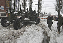 Army dozers clear snow in Srinagar on Tuesday.