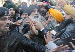 SAD President Parkash Singh Badal trying to regain his composure after being hit by a water cannon in Chandigarh on Saturday. 