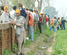 Helpers outside Government Secondary School, Gharyala, near Tarn Taran, on Friday. Mass copying was reported during the matriculation examinations of the Punjab School Education Board in border villages of the area.