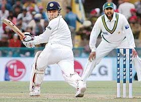 Virender Sehwag plays a sweep shot off Danish Kaneria