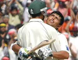 Pakistan's wicketkeeper-batsman Kamran Akmal hugs Abdul Razzaq on completing his century