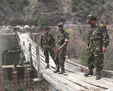 Army officers inspect the Indian part of the bridge which is being raised jointly by India and Pakistan near the LoC on Monday.