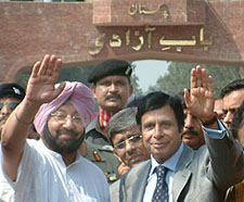 Punjab Chief Minister Capt Amarinder Singh and Mr Pervaiz Elahi, Chief Minister of Pakistan Punjab, wave to Indians after the former crossed over to Pakistan on Monday.