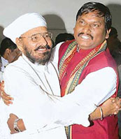 Newly elected Jharkhand Assembly Speaker Inder Singh Namdhari and Chief Minister Arjun Munda embrace each other after winning the trust vote by 40 to 38 in Ranchi 