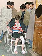 A schoolboy being taken in a wheelchair after he was injured in an explosion in a school at Nadihal, Baramula, on Friday. 