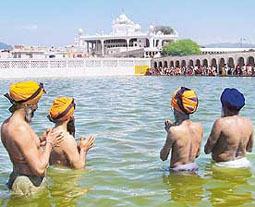 Devotees take the holy dip in the sarovar of Takht Sri Kesgarh Sahib in Anandpur Sahib on Thursday.