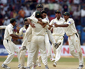 Pakistan players celebrate their victory over India in the third and final Test match in Bangalore on Monday.