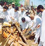 Haryana Power Minister and steel baron O.P. Jindals eldest son Prithvi Raj lights his fathers pyre in Hisar on Friday. 