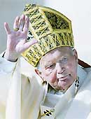 Pope John Paul II waves during a consistory in Saint Peters Square at the Vatican in this October 21, 2003, file photo. 