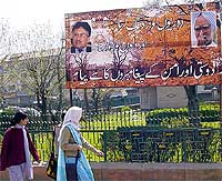 College girls watching the Pervez Musharraf-Manmohan Singh board near a park in Srinagar on Saturday. 