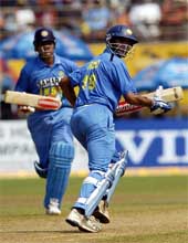 Rahul Dravid (right) and Virender Sehwag run between the wickets during the first one-day match against Pakistan in Kochi on Saturday. Both batsmen scored centuries and India won the match by 87 runs.