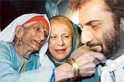An old woman touches the face of her nephew who came by the first Srinagar-Muzaffarabad bus service