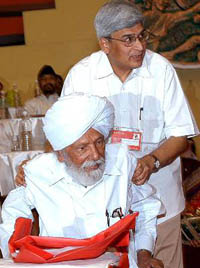 Newly elected General Secretary of CPI (M) Prakash Karat assists Harkishen Singh Surjeet at the 18th Congress of the party in New Delhi on Monday.