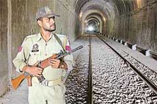 A policeman stands guard inside a railway tunnel at the Jammu-Udhampur railway track on the outskirts of Jammu on Tuesday.