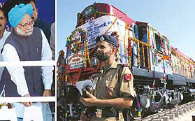 Prime Minister Manmohan Singh presses the button to mark the flagging off the Uttar Sampark Kranti Express in Udhampur on Wednesday and (right) jawans stand guard along a bedecked train at Udhampur.