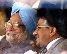 Indian Prime Minister Manmohan Singh and Pakistani President Pervez Musharraf share a light moment as they watch the sixth ODI between India and Pakistan in New Delhi
