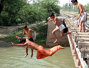 With the onset of the summer season, young boys jump into the Bathinda branch of the Sirhind canal to take a relief from the scorching heat.