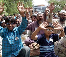 Amir and Nadeem wave to express happiness along with other Pakistani fishermen at Wagah Border before being repatriated to their homeland on Tuesday