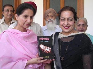 Patiala MP Preneet Kaur releases a book on childcare in Patiala on Tuesday. On right is the author Dr Harshinder Kaur.