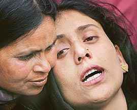 A relative comforts a wailing woman who lost a close relative when militants hurled a grenade killing two civilians in Sopore, 55 km north of Kashmir, on Wednesday.