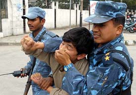 Nepali police personnel arrest supporters of the Nepali Congress in front of the Royal Commission for Corruption Control office in Kathmandu where former Prime Minister Sher Bahadur Deuba was taken to following his arrest on Wednesday. 