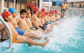 Young swimmers get ready for a cool dip in a pool as temperatures soared in Ludhiana on Saturday