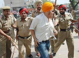 Police round up one of the activists during the protests against the screening of the film Jo Bole So Nihal in Jalandhar on Friday. 