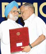 Prime Minister Manmohan Singh greets Ram Narain Agarwal, the Lifetime Achievement Award winner of Distinguished Scientist during a Defence Research and Development Organisation technology awards presentation ceremony in New Delhi on Tuesday.