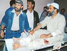 A wounded person is carried to a hospital in Srinagar after a grenade explosion on the outskirts of Srinagar left two persons killed and 20 injured. 