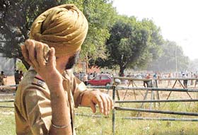 A Chandigarh policeman aims a stone at agitating workers at the Matka Chowk in Chandigarh