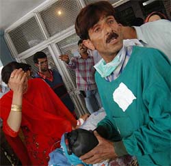 A grenade blast victim is rushed to hospital after militants detonated a grenade in the market at Dal Gate in Srinagar