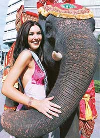 Miss Universe 2005 Natalie Gleova of Canada poses with nine-year old elephant Num Choke, whose name means Bringing Luck, hours after winning the Miss Universe 2005 title in Bangkok
