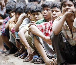 Child labourers rescued from different factories sit huddled at a police station in Mumbai on Wednesday.